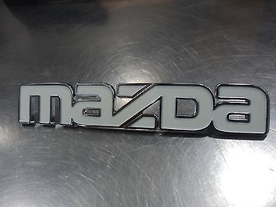Mazda OEM 323, 626, B series, MPV & GLC front white emblem G030-51-771