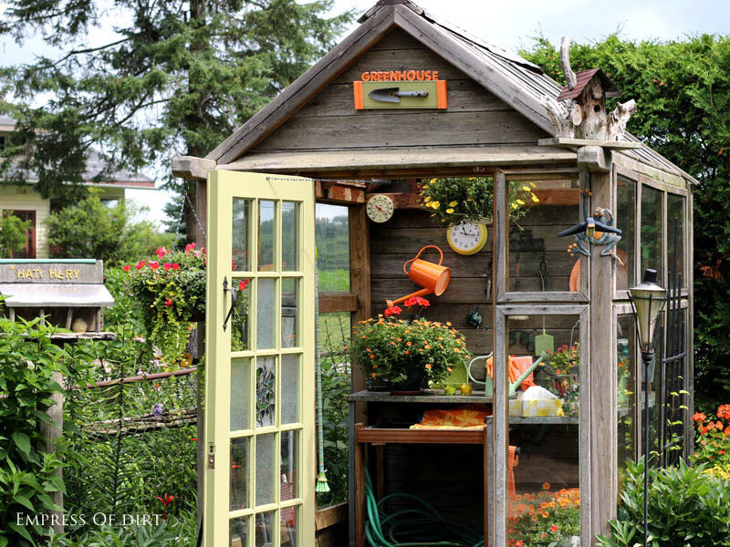  little wooden potting shed is filled with clever garden art ideas