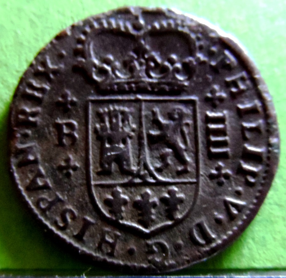 bala de cañon y moneda encontrada cerca una muralla derruida $_57