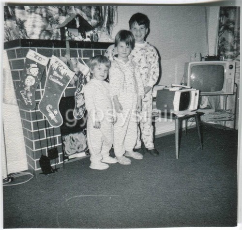 1950s-Vintage-Photo-Kids-in-Footy-PJs-by-Christmas-Stockings-on-Fake-Fire-Place