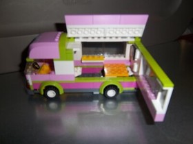 Lego 3184 Friends Camping Set with RV, minifigures, bikes, table, and manuals
