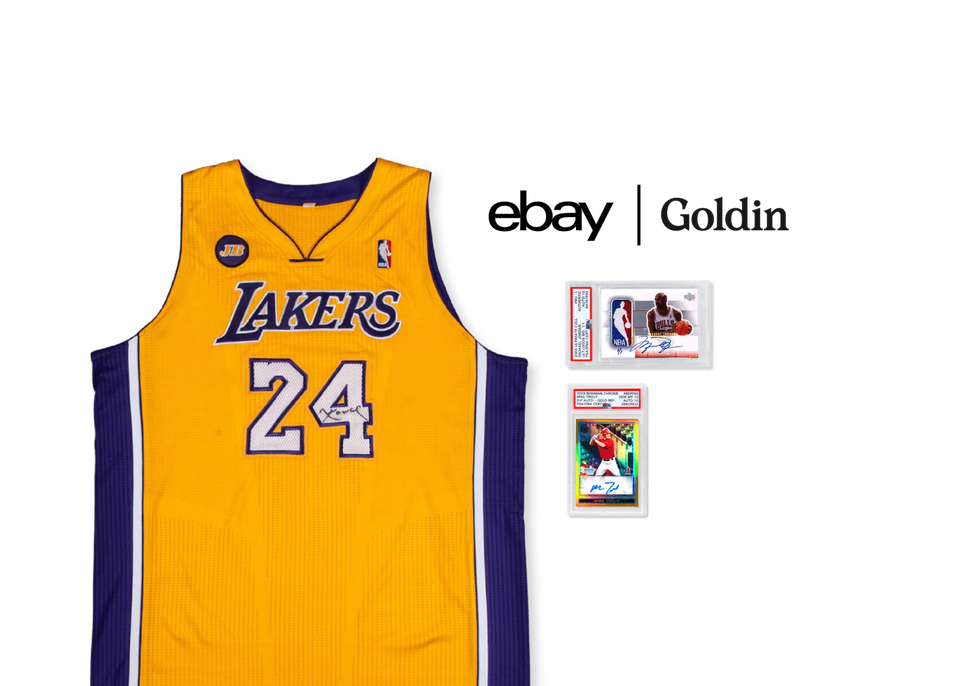 A Kobe Bryant game-used signed Los Angeles Lakers jersey, a 2003-04 Upper Deck signed Michael Jordan patch card, and a 2009 chrome autographed Mike Trout rookie card sit on a yellow background. The eBay and Goldin logos in black sit in the top right corner.