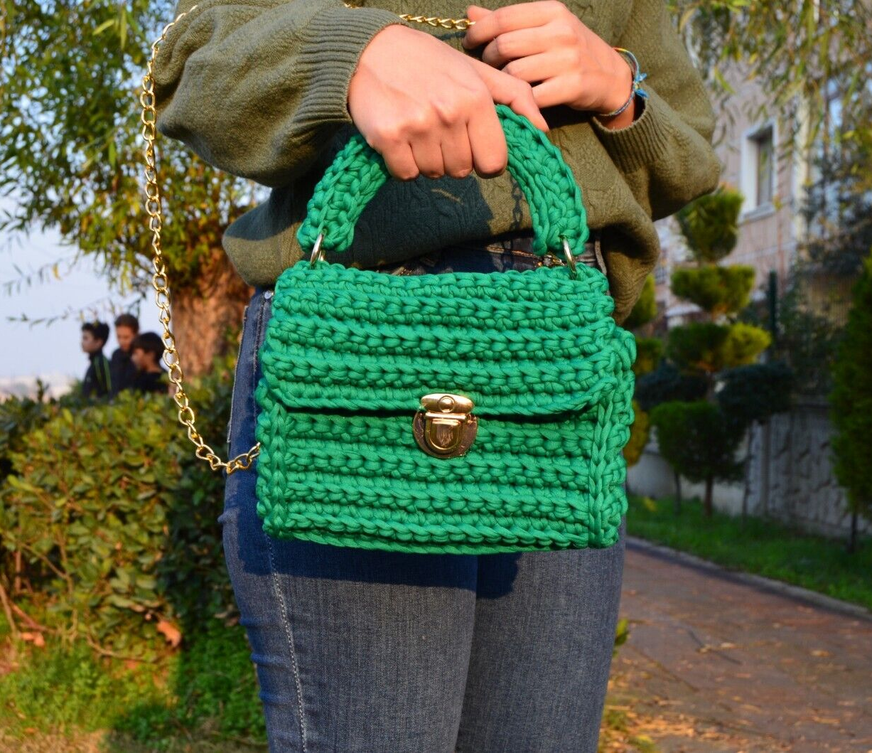 Vivid crochet shoulder bag on a table with knitting supplies on Craiyon