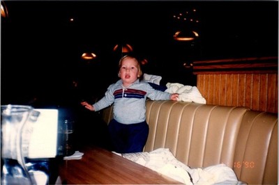 Baby Boy Standing At Table In Restaurant Found Photo V2282