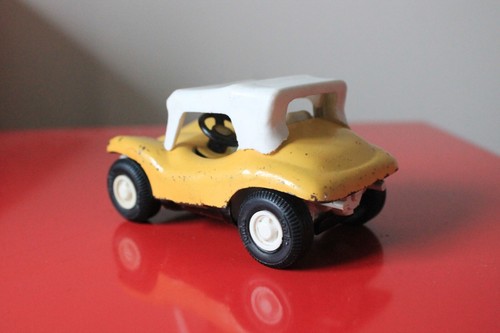 red plastic car with yellow roof