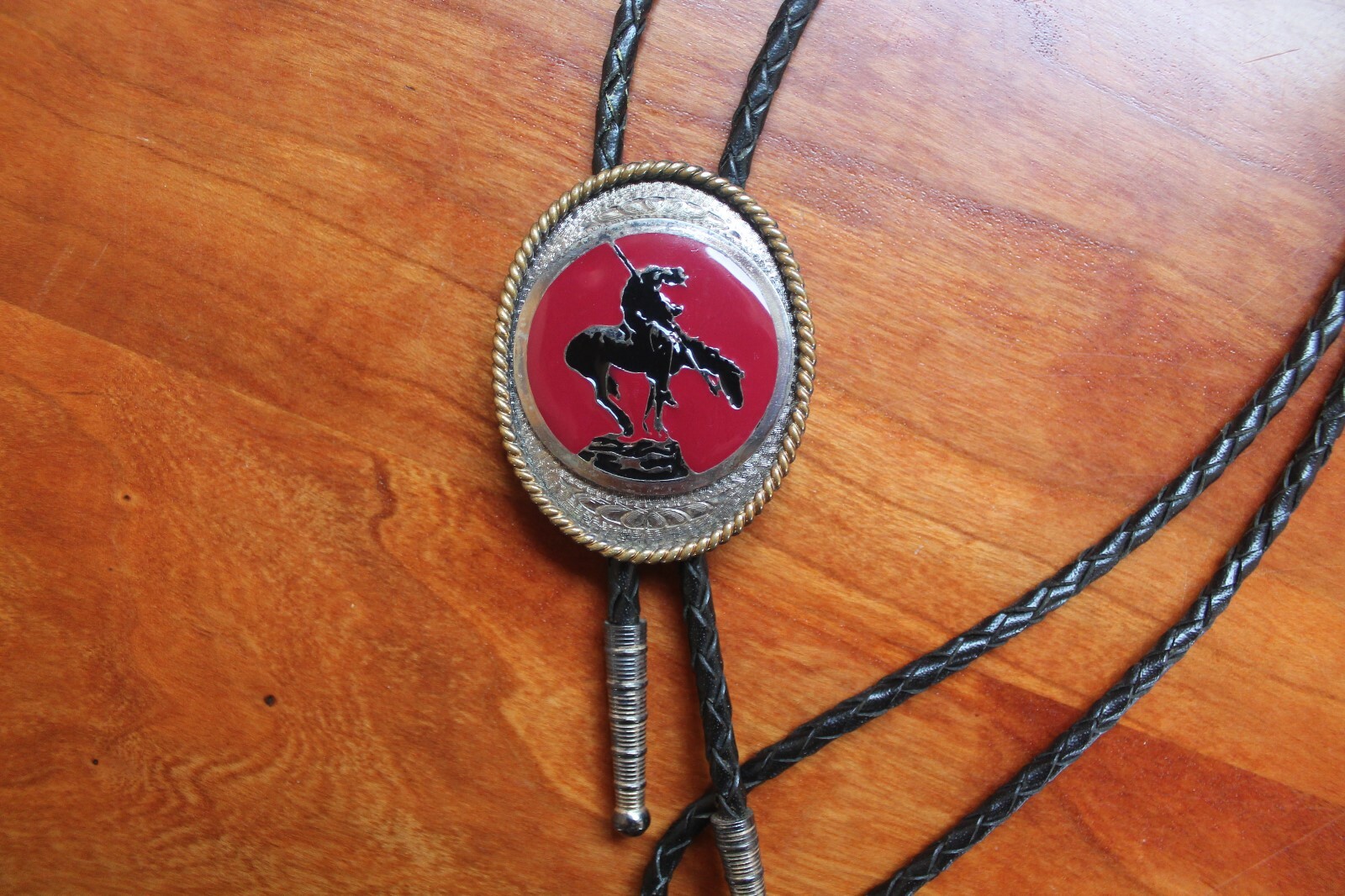 Western Men’s Bolo Neck Tie Metal Oval with Horse etched into a Red Background