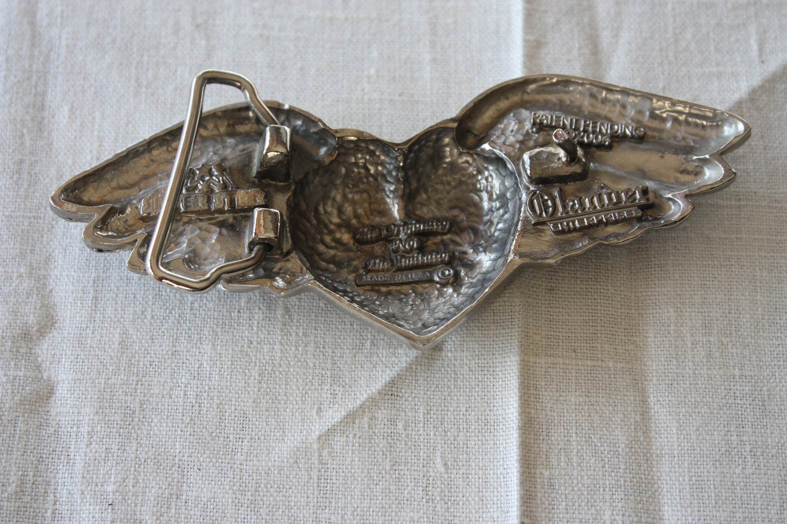 VINTAGE METAL BELT BUCKLE SILVER STAR WINGED HEART MARKED MADE IN THE USA 2004