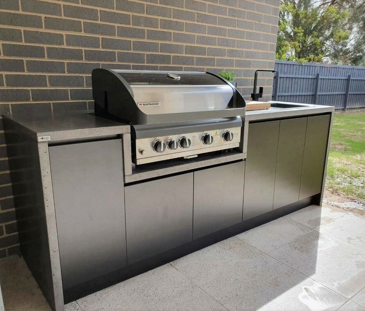 Outdoor kitchen polished real concrete benchtop and outdoor cabinetry