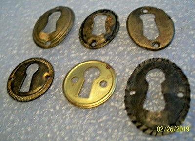 6 -  PRESSED BRASS, ANTIQUE KEY HOLE ESCUTCHEONS, USED CONDITION, 1 IS HAND MADE