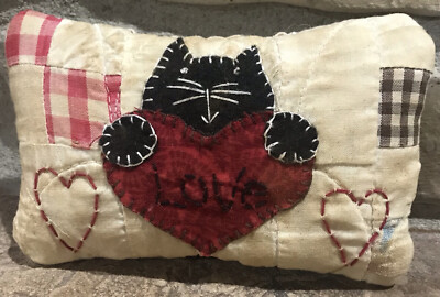 Decorative cat-shaped cushion made by hand in punch needle with heart decoration