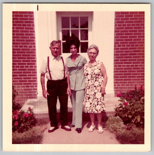 Vtg Color Snapshot Family 3 Three People Standing Brick Building Doorway Flower