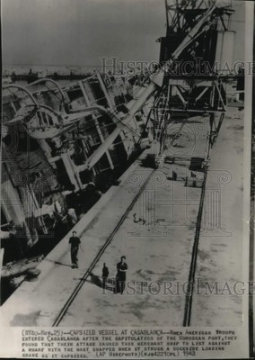 1942 Press Photo Ship struck dockside loading crane due to US attack, Africa