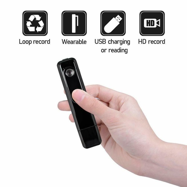 Hand holding a portable HD wearable camera with USB.