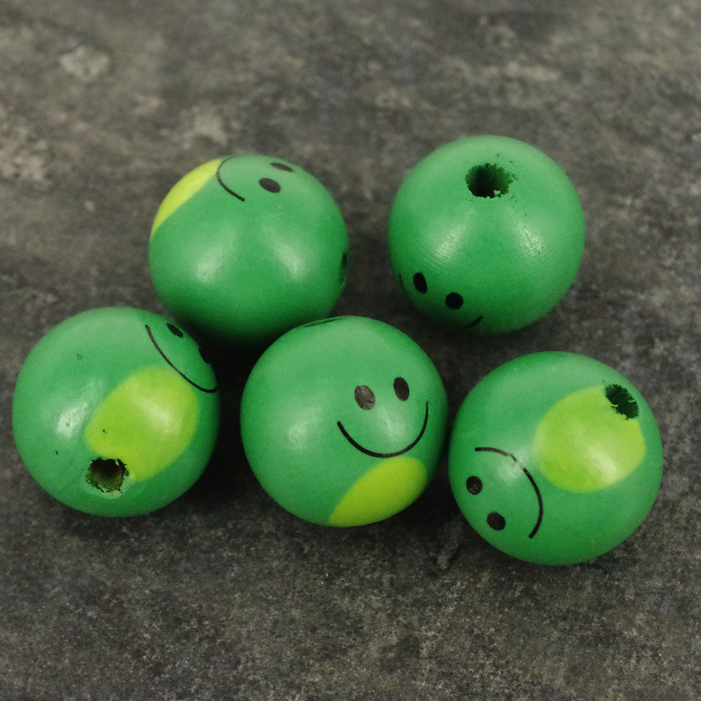 wooden doll heads with faces