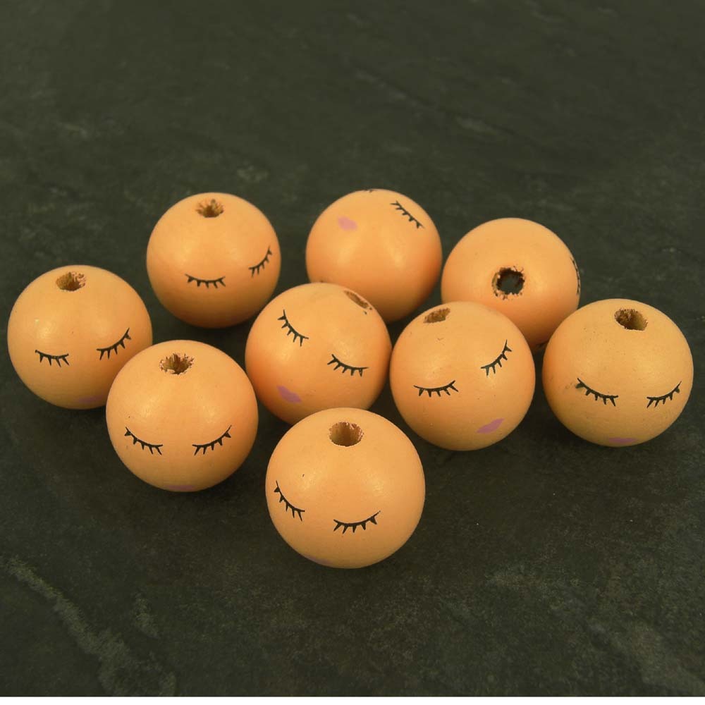 wooden doll heads with faces