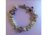 Pandora bracelet with 19 beautiful gold and silver charms and Murano glass beads.