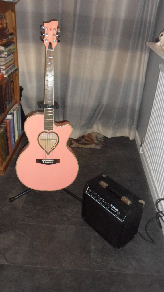 Semi acoustic Pink guitar with stand and 15 amp amplifier in Spalding