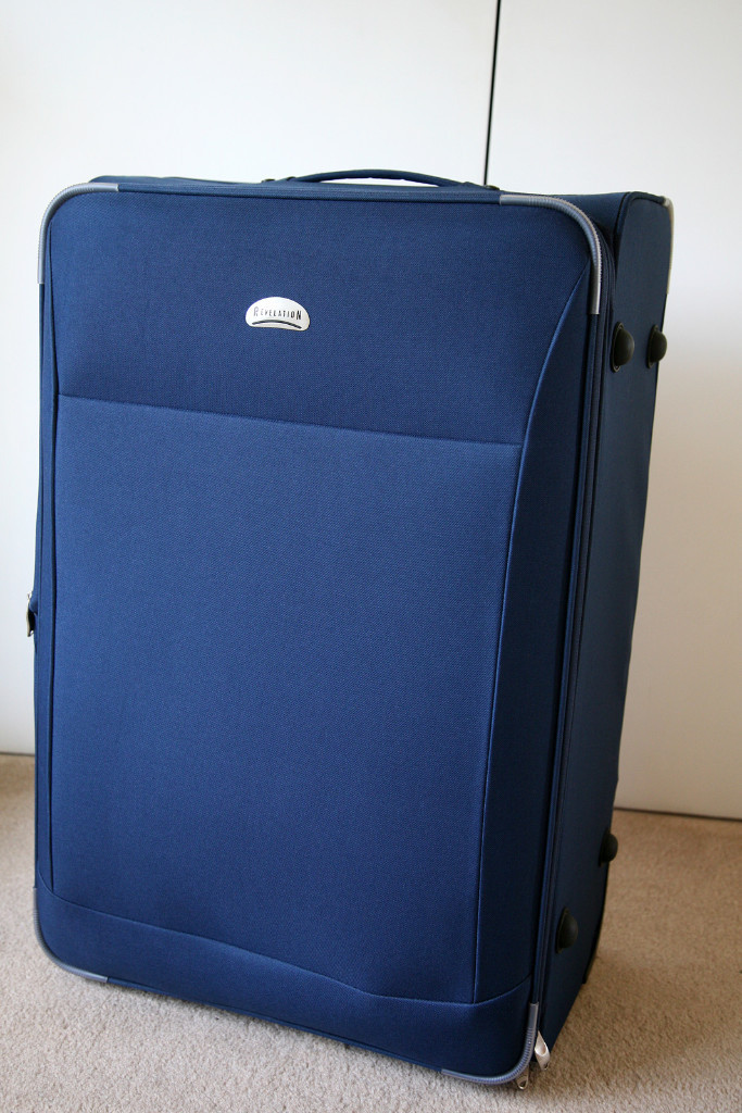 Revelation large blue fabric suitcase with wheels unused excellent