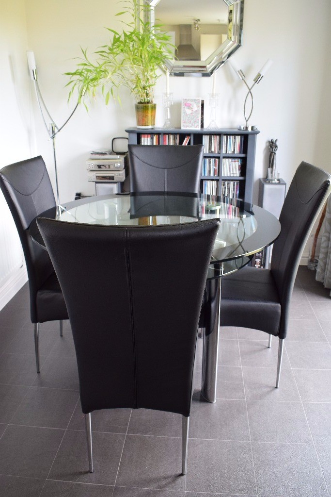 Circular Glass Dining Table & 4 Black Faux Leather Chairs in