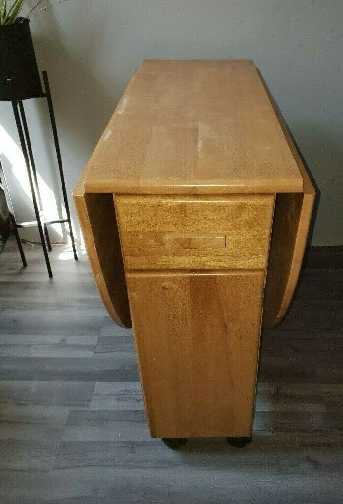 Pine drop leaf extending dining table with storage