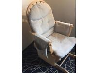 Nursing solid wood rocking chair with removable washable cushions.