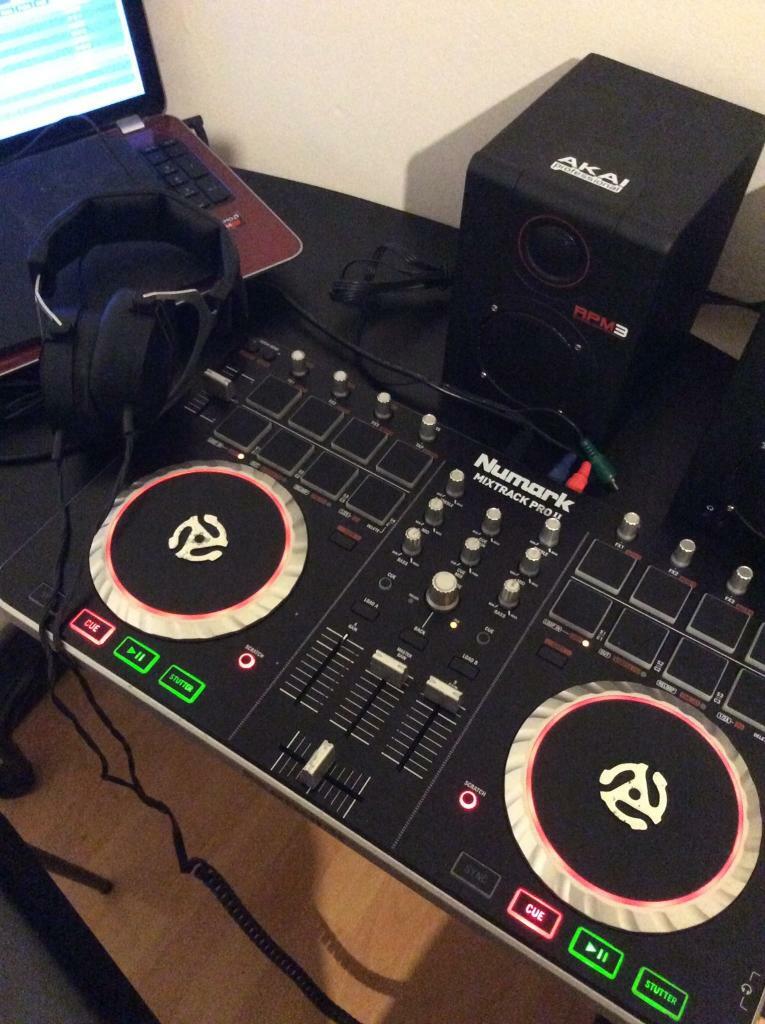 Dj decks numark mixtrak pro 2 with leads and a set of speakers in