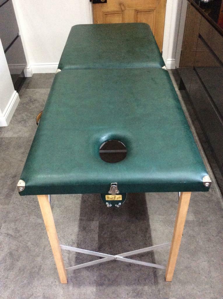 Portable folding massage table with tapered face hole, green in