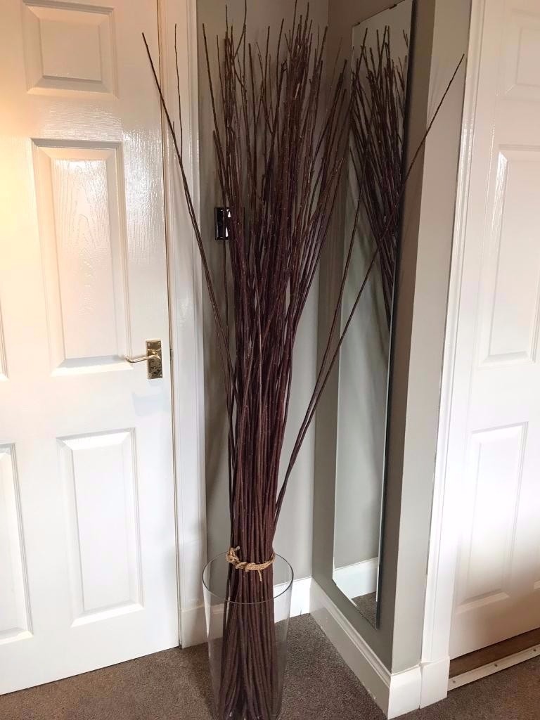 Decorative IKEA SMYKA tied willow branches in large glass vase (also