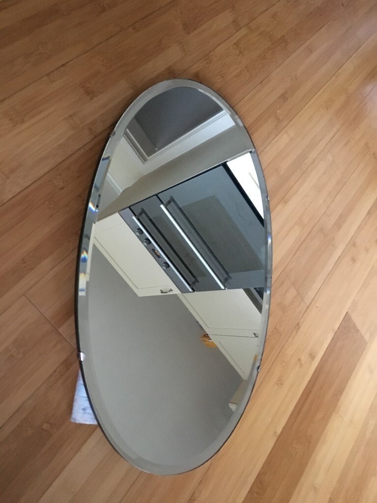 Vintage Oval shaped mirror, frameless has bevel edged mirror glass