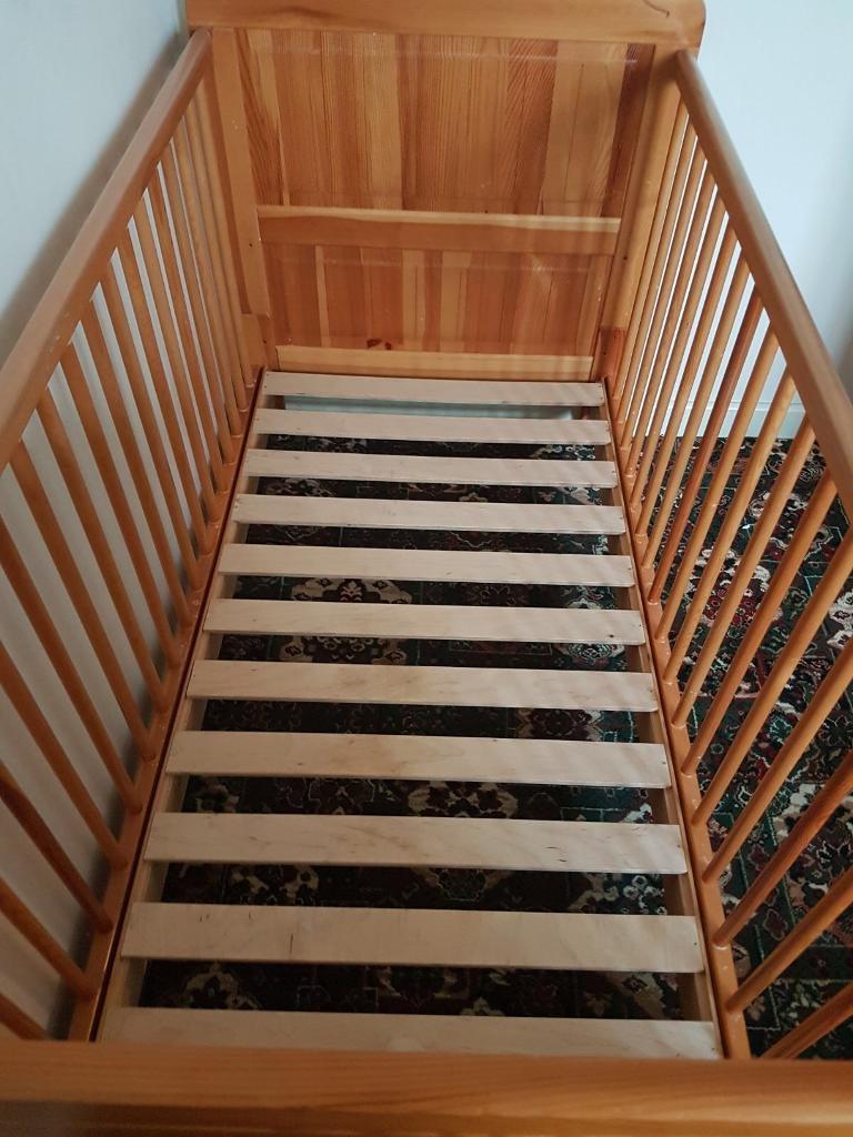 Pine cot bed with teething rails and freebies in Beeston
