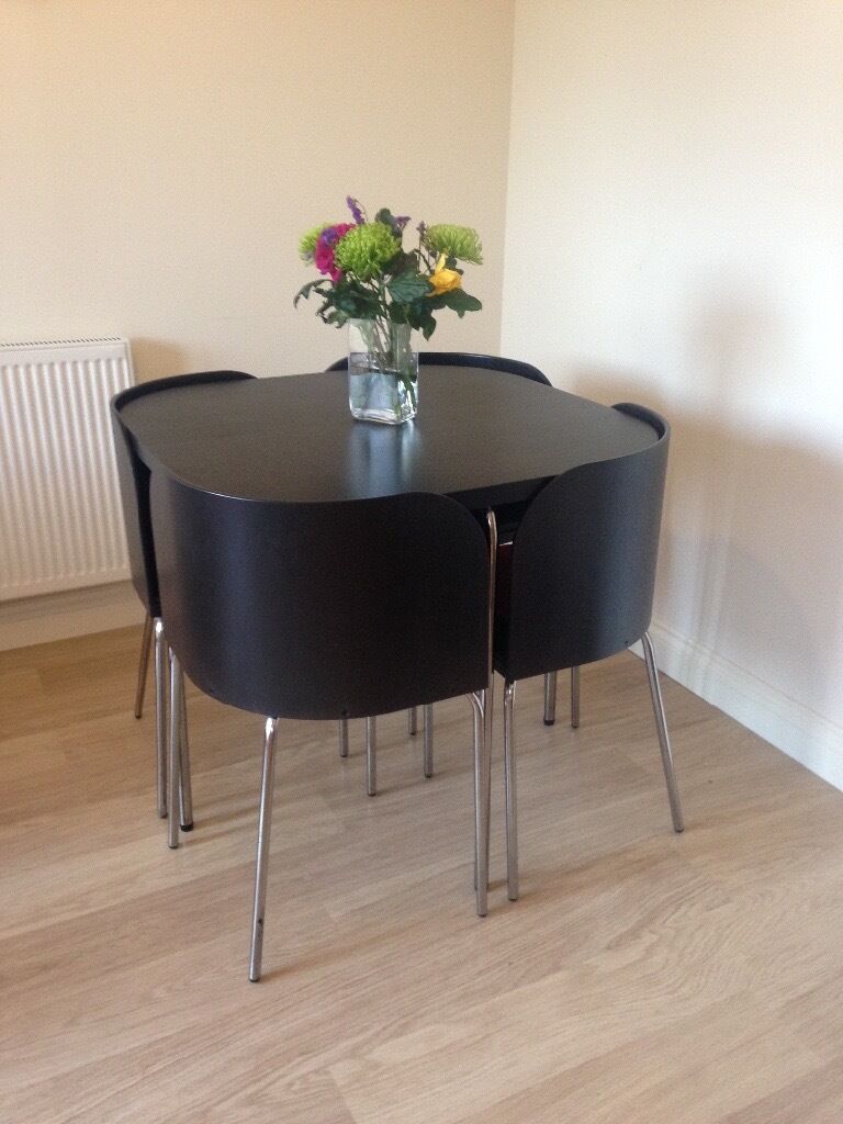 Ikea dining table and four chairs. Neat,space saving dining table and