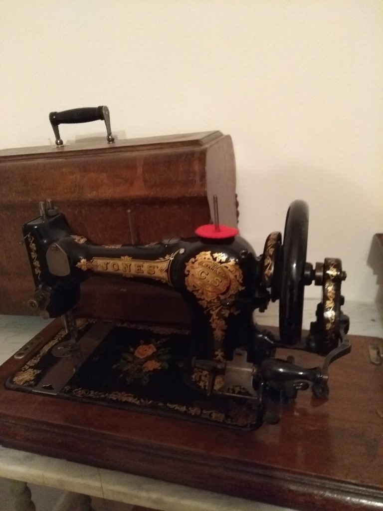 Jones vintage sewing machine with wooden case. Early 1900 century. in