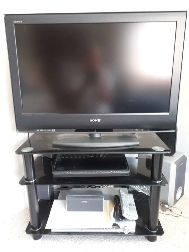 Sony Bravia TV with stand and DVD player with surround sound speakers