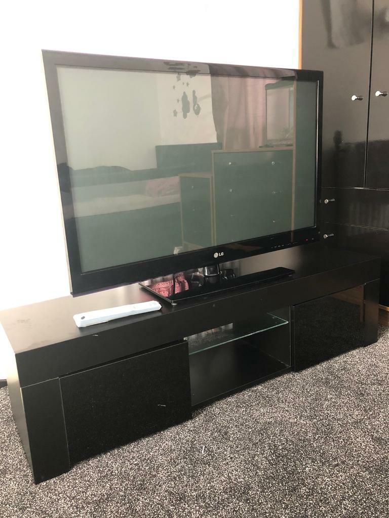 42” LG TV with black gloss tv and remote control in