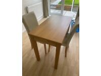 Solid oak dining table and chairs