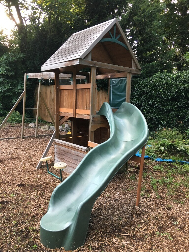 Sturdy kids playground with swings, slide, monkey bars, watch tower