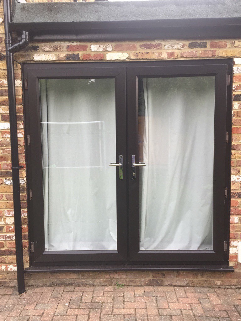 2 Sets of UPVC Patio Doors. Black frames on outside, white on inside A