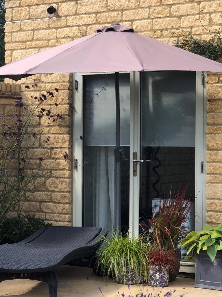 Balcony half sized parasol with base in Cirencester, Gloucestershire