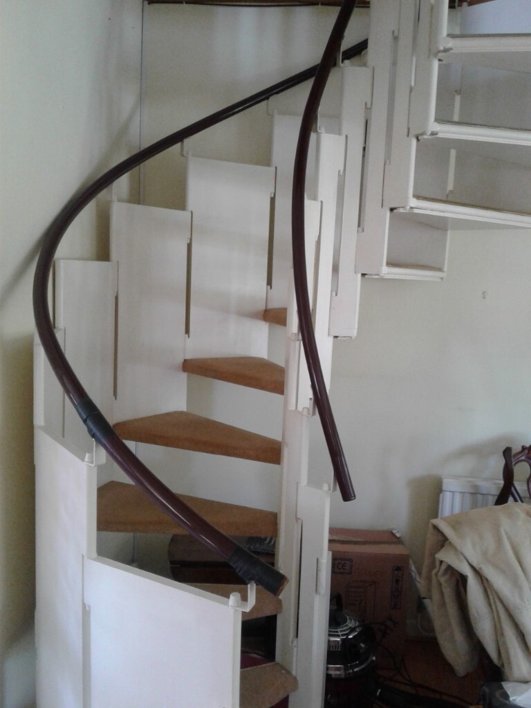 Quality spiral staircase with carpeted wooden treads. Strong rail and