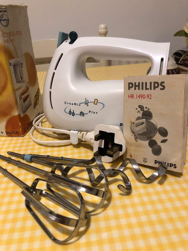Philips hand mixer with attachments and instructions in