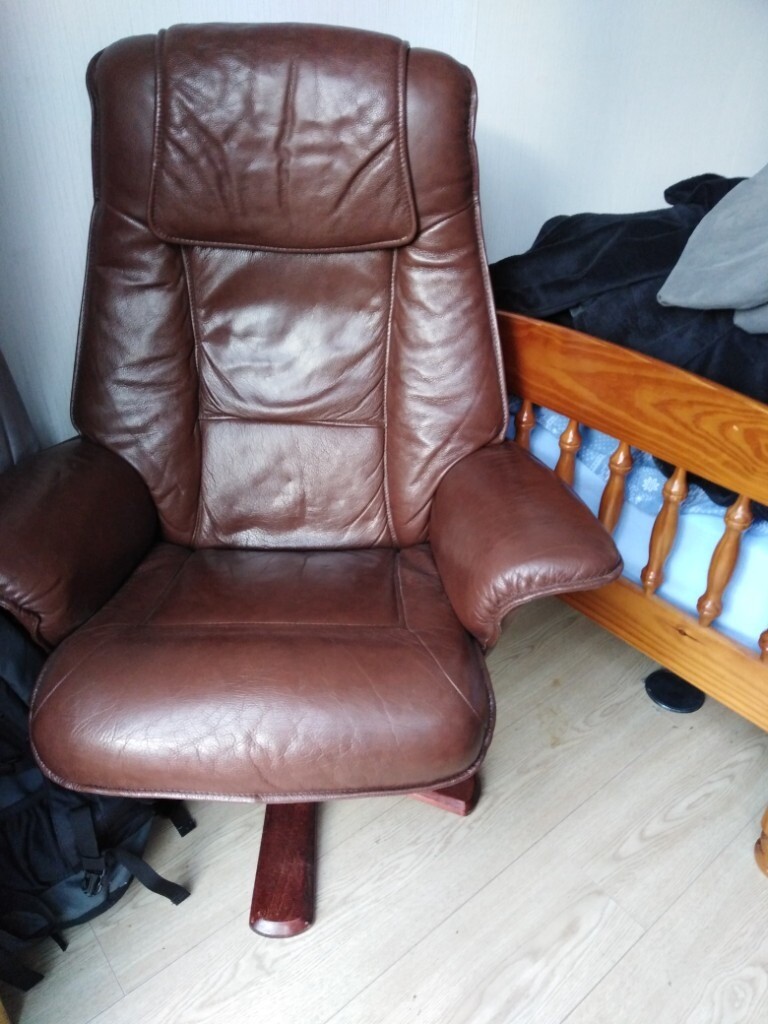 Brown leather chair and matching stool in Livingston, West Lothian