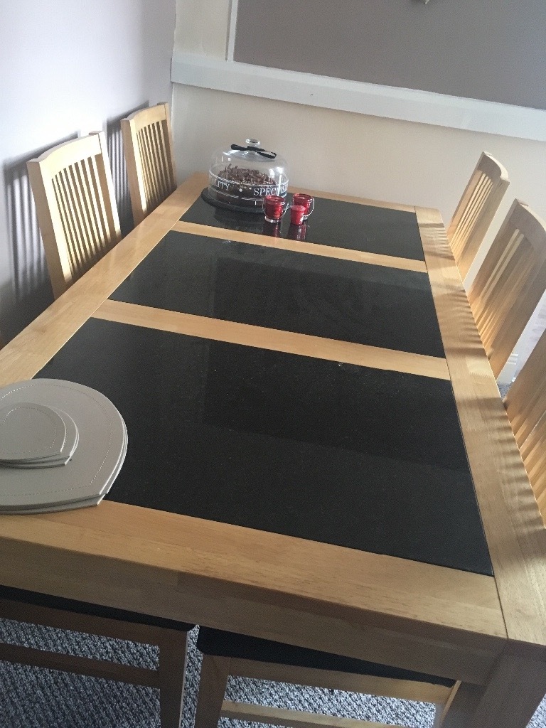 Solid wood dining table with black granite inserts and six chairs with