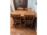 Solid hardwood table and four chairs - good condition 