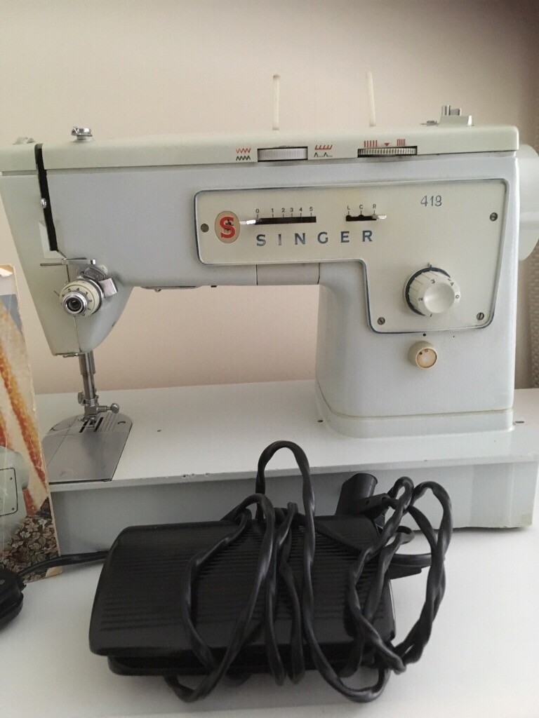 Singer electric sewing machine 413 complete with attachments and