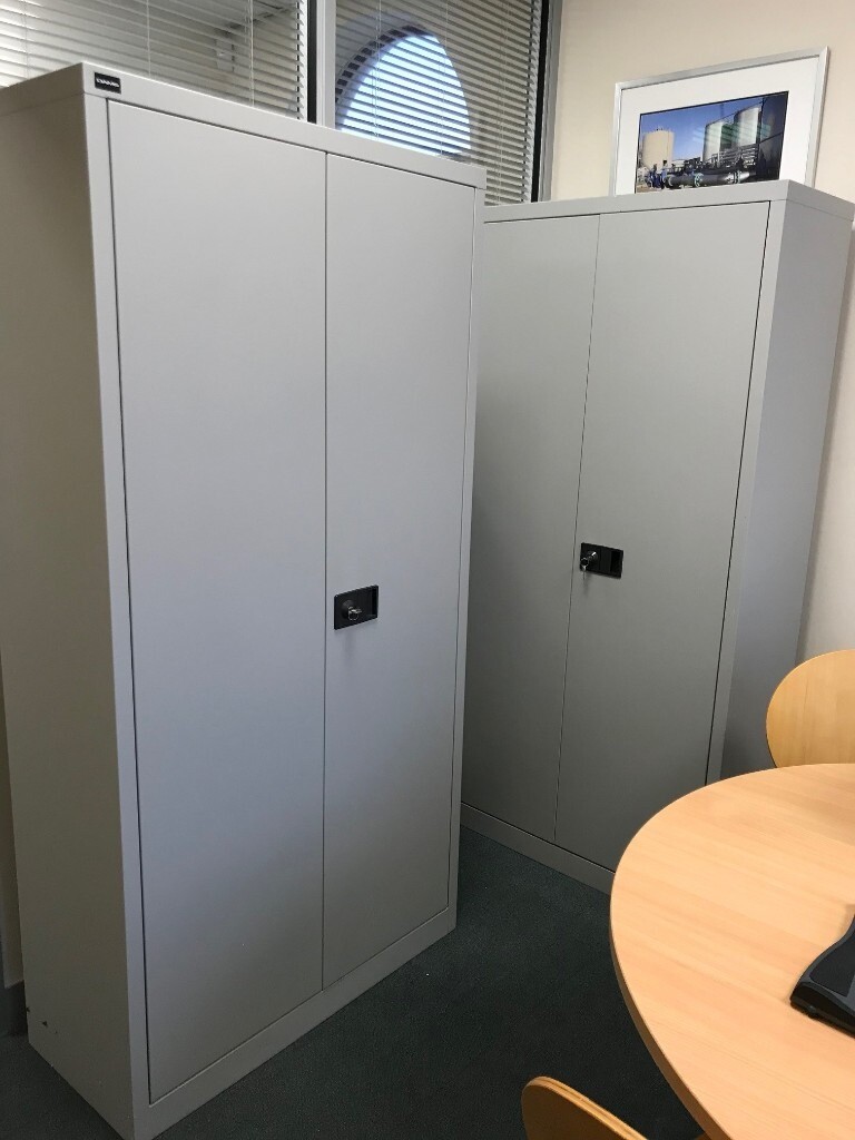 Two lockable steel office cupboards, complete with set of keys and
