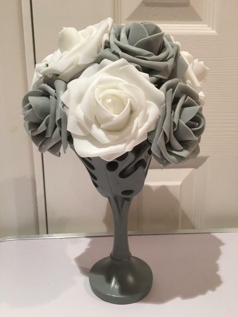 Artificial flower arrangement in grey vase grey and white flowers in