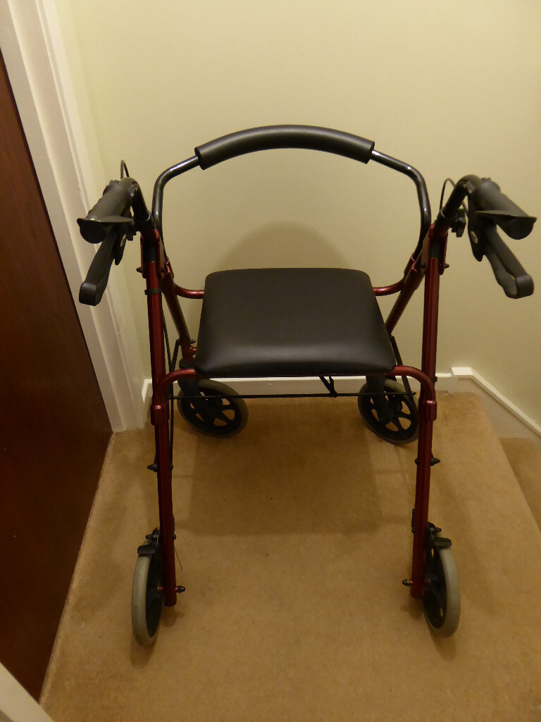 2nd hand 4wheeled rollator/walker; sturdy; maroon, with seat; removable protective bar; hand