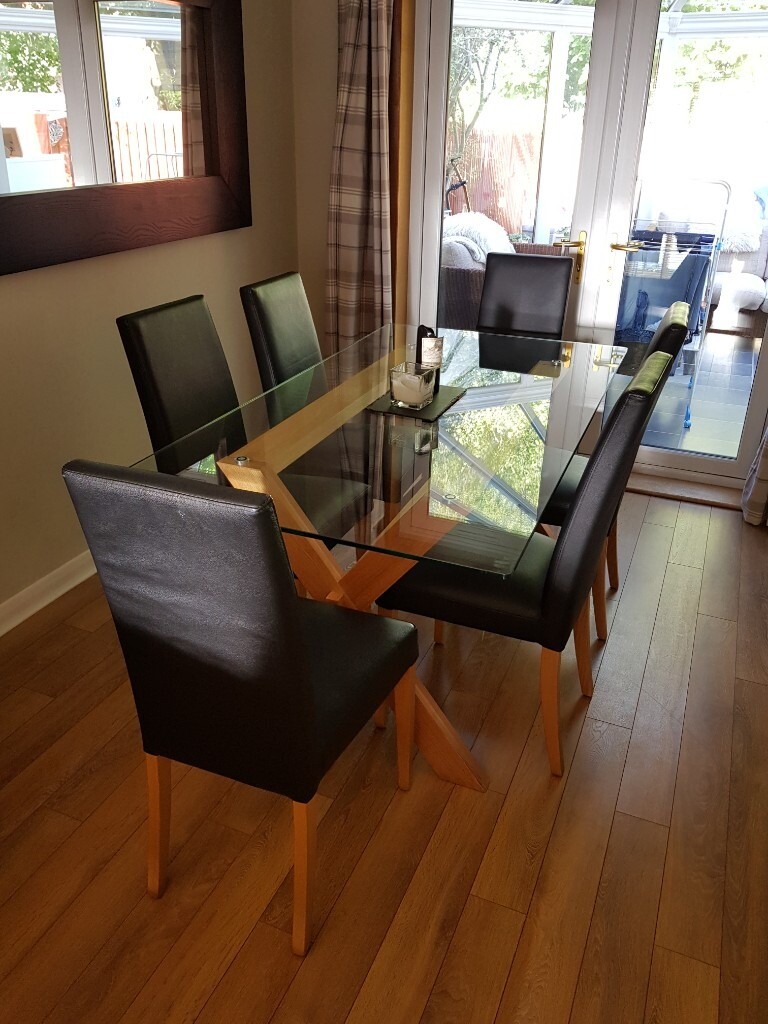 M&S Solid oak and Glass dining table with 6 black leather chairs in