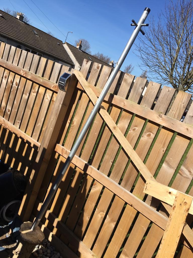 Galvanised steel washing line post and a bag of postcrete in