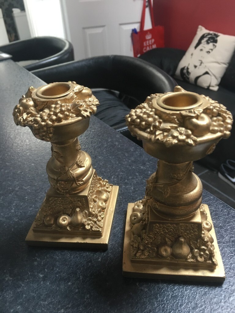 Pair of unusual ornate gold candle sticks in Saffron Walden, Essex